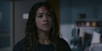 Movie still from “Awake” (2021), directed by Mark Raso – A person with long curly hair; Close Up shot, Over the shoulder angle