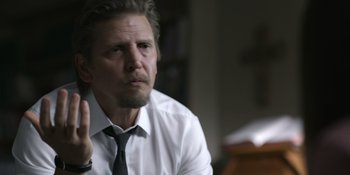 Movie still from “Awake” (2021), directed by Mark Raso – A person wearing a shirt and a tie; Close Up shot, Over the shoulder angle