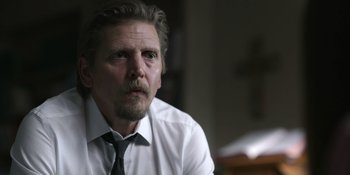 Movie still from “Awake” (2021), directed by Mark Raso – A person wearing a shirt and a tie; Close Up shot, Over the shoulder angle