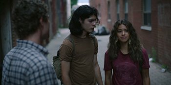 Movie still from “Awake” (2021), directed by Mark Raso – A man and a woman walking down a street; Medium shot, Over the shoulder angle