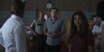 Movie still from “Awake” (2021), directed by Mark Raso – A group of people standing in front of a building; Medium shot, Low angle