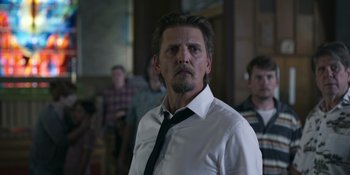 Movie still from “Awake” (2021), directed by Mark Raso – A person wearing a shirt and a tie; Close Up shot, Low angle