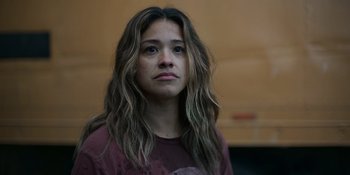 Movie still from “Awake” (2021), directed by Mark Raso – A woman with long hair is looking into the distance; Close Up shot, Low angle