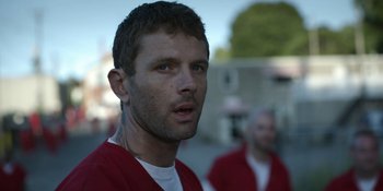 Movie still from “Awake” (2021), directed by Mark Raso – A person wearing a red shirt; Close Up shot, Over the shoulder angle