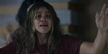 Movie still from “Awake” (2021), directed by Mark Raso – A woman with long brown hair is crying; Close Up shot, High angle