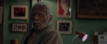 Movie still from “Baby Driver” (2017), directed by Edgar Wright – An older man with a gray beard looking into the distance; Close Up shot, Over the shoulder angle