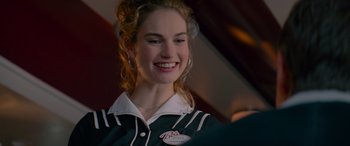 Movie still from “Baby Driver” (2017), directed by Edgar Wright – A woman smiling for the camera while wearing a black and white shirt; Close Up shot, Over the shoulder angle