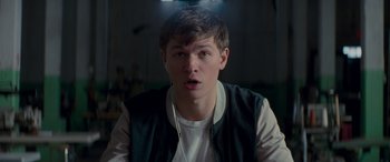 Movie still from “Baby Driver” (2017), directed by Edgar Wright – A young man with a surprised look on his face; Close Up shot, Low angle