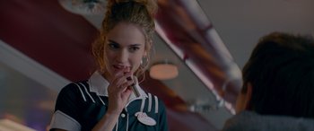 Movie still from “Baby Driver” (2017), directed by Edgar Wright – A woman holding a cigarette in her mouth; Close Up shot, Over the shoulder angle