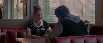 Movie still from “Baby Driver” (2017), directed by Edgar Wright – A man and a woman sitting at a table in front of a window; Medium shot, Over the shoulder angle