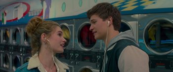 Movie still from “Baby Driver” (2017), directed by Edgar Wright – A man and a woman wearing ear phones in front of a washing machine; Close Up shot, Over the shoulder angle