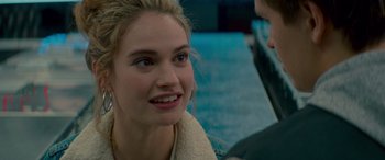 Movie still from “Baby Driver” (2017), directed by Edgar Wright – A young woman smiles at the camera as she talks to a man; Close Up shot, Over the shoulder angle
