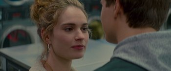 Movie still from “Baby Driver” (2017), directed by Edgar Wright – A young woman and a young man looking at one another; Close Up shot, Over the shoulder angle