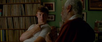 Movie still from “Baby Driver” (2017), directed by Edgar Wright – A young man and an older man sitting in front of each other; Close Up shot, Over the shoulder angle