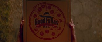 Movie still from “Baby Driver” (2017), directed by Edgar Wright – A pizza box that has a logo on it; Extreme Close Up shot, High angle