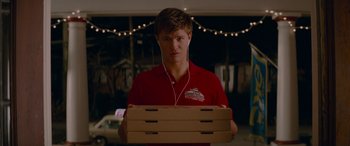 Movie still from “Baby Driver” (2017), directed by Edgar Wright – A man in a red shirt is holding two boxes; Medium shot, Over the shoulder angle