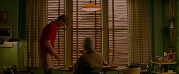 Movie still from “Baby Driver” (2017), directed by Edgar Wright – Two people sitting at a table in front of a window; Medium shot, Over the shoulder angle