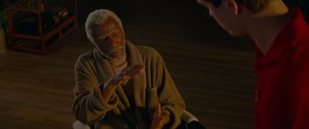 Movie still from “Baby Driver” (2017), directed by Edgar Wright – An older man wearing a robe talking to someone; Medium shot, High angle