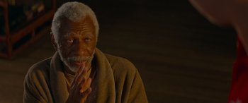 Movie still from “Baby Driver” (2017), directed by Edgar Wright – An older man with a beard and a towel around his neck; Close Up shot, High angle