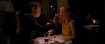 Movie still from “Baby Driver” (2017), directed by Edgar Wright – A man feeding a woman a piece of cake at a table; Medium shot, Over the shoulder angle