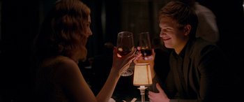 Movie still from “Baby Driver” (2017), directed by Edgar Wright – A man and a woman are holding wine glasses; Medium shot, Over the shoulder angle