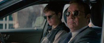 Movie still from “Baby Driver” (2017), directed by Edgar Wright – A man and a woman sitting in the back of a car; Close Up shot, Over the shoulder angle