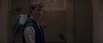 Movie still from “Baby Driver” (2017), directed by Edgar Wright – A young man with headphones standing in a room; Close Up shot, Over the shoulder angle