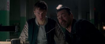 Movie still from “Baby Driver” (2017), directed by Edgar Wright – A man and a young boy are listening to music together; Close Up shot, Over the shoulder angle