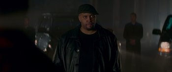 Movie still from “Baby Driver” (2017), directed by Edgar Wright – A man wearing a black hat and a leather jacket; Close Up shot, Low angle