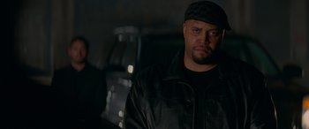 Movie still from “Baby Driver” (2017), directed by Edgar Wright – A man wearing a black hat and a leather jacket; Close Up shot, Low angle