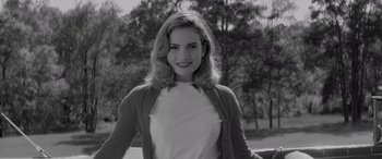 Movie still from “Baby Driver” (2017), directed by Edgar Wright – Black and white photograph of a young woman in a park; Medium shot, Low angle