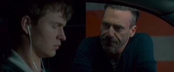 Movie still from “Baby Driver” (2017), directed by Edgar Wright – A man looking at another man in a car mirror; Close Up shot, Over the shoulder angle