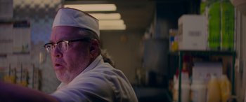 Movie still from “Baby Driver” (2017), directed by Edgar Wright – A man in a chef's hat is in a kitchen; Close Up shot, Low angle