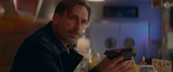 Movie still from “Baby Driver” (2017), directed by Edgar Wright – A person holding a gun; Close Up shot, Over the shoulder angle