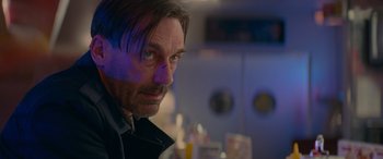 Movie still from “Baby Driver” (2017), directed by Edgar Wright – A person wearing a black jacket; Close Up shot, Over the shoulder angle