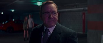 Movie still from “Baby Driver” (2017), directed by Edgar Wright – An older man wearing a suit and tie; Close Up shot, Low angle