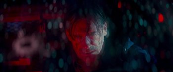 Movie still from “Baby Driver” (2017), directed by Edgar Wright – A man with red and blue lights in the background; Close Up shot, Low angle