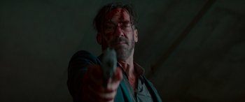 Movie still from “Baby Driver” (2017), directed by Edgar Wright – A man with blood on his face holding a gun; Close Up shot, Low angle