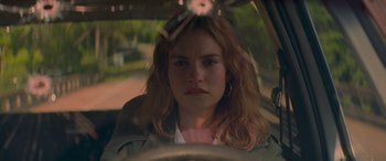 Movie still from “Baby Driver” (2017), directed by Edgar Wright – A woman sitting in the drivers seat of a car; Close Up shot, Over the shoulder angle