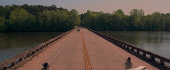 Movie still from “Baby Driver” (2017), directed by Edgar Wright – A car is driving on a bridge over a river; Extreme Wide shot, High angle