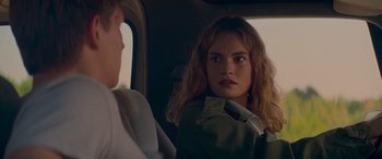 Movie still from “Baby Driver” (2017), directed by Edgar Wright – A woman sitting in the back seat of a car; Close Up shot, Over the shoulder angle