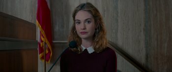 Movie still from “Baby Driver” (2017), directed by Edgar Wright – A woman in a red sweater is standing in front of a microphone; Close Up shot, Over the shoulder angle