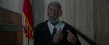 Movie still from “Baby Driver” (2017), directed by Edgar Wright – An older man wearing a neck tie pointing to his chest; Close Up shot, Low angle