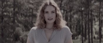 Movie still from “Baby Driver” (2017), directed by Edgar Wright – A beautiful young woman with long , blonde hair and wearing a polka dot shirt; Close Up shot, Low angle