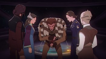Movie still from “Babylon 5: The Road Home” (2023), directed by Matt Peters – A group of people standing around an animated creature; Medium shot, High angle