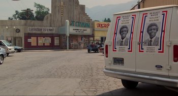 Movie still from “Back to the Future” (1985), directed by Robert Zemeckis – A white van parked on the side of the street; Wide shot, High angle