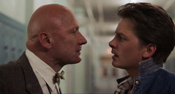 Movie still from “Back to the Future” (1985), directed by Robert Zemeckis – A man and a woman face to face in front of each other; Close Up shot, Over the shoulder angle