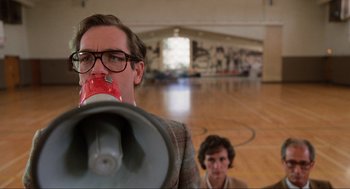 Movie still from “Back to the Future” (1985), directed by Robert Zemeckis – A man and a woman are standing in a gym; Medium shot, Low angle