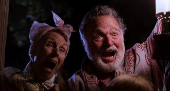 Movie still from “Back to the Future” (1985), directed by Robert Zemeckis – An older man and a younger woman are making funny faces; Close Up shot, Low angle
