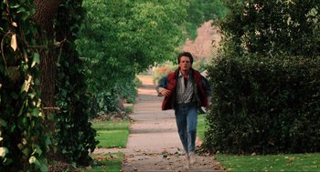 Movie still from “Back to the Future” (1985), directed by Robert Zemeckis – A man walking down a path in the woods; Wide shot, High angle